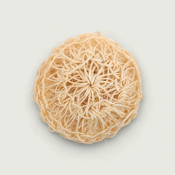Round sisal body scrubber showing its natural woven texture.