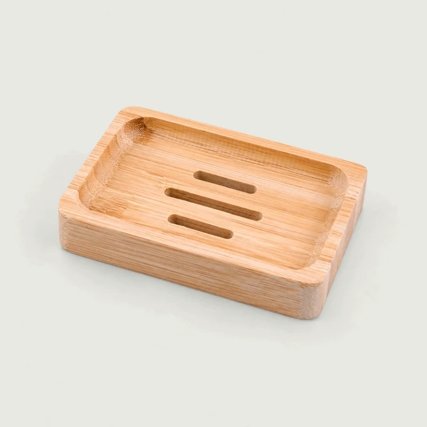 Slotted bamboo soap dish with three open drainage slots.